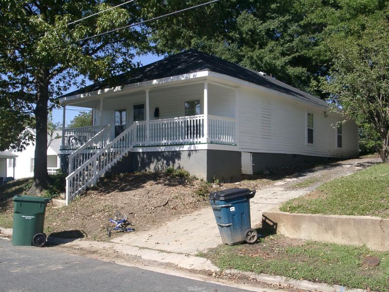 A street view of a one-story white house at 601 Gray Avenue.