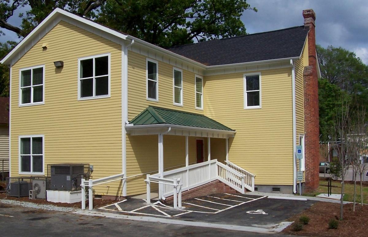 The piece meal additions to the back of this building were removed and a new wing constructed.